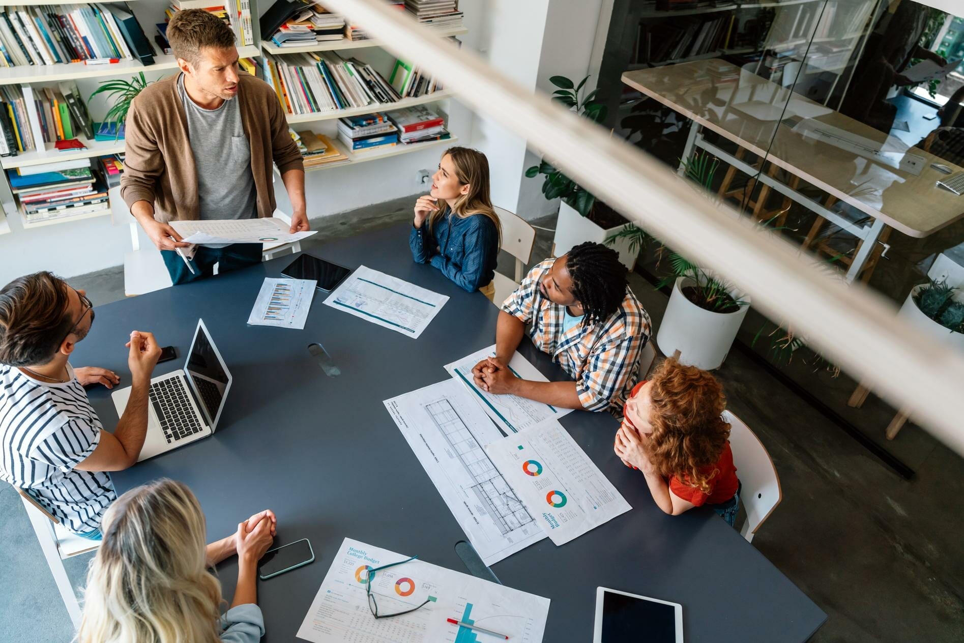 Group of successful business people, designers working together on project in office